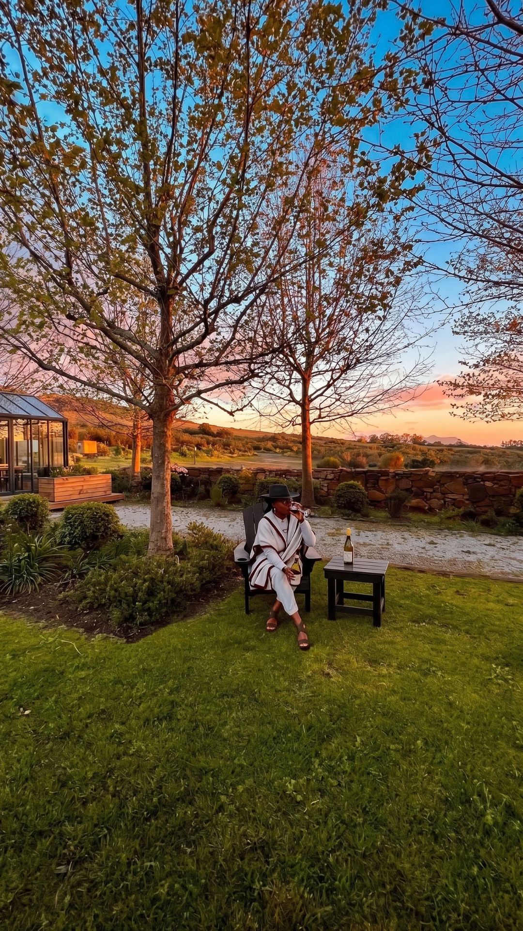Tomiko Harvey relaxing in the garden of a Cape Winelands wine estate near Cape Town at sunset