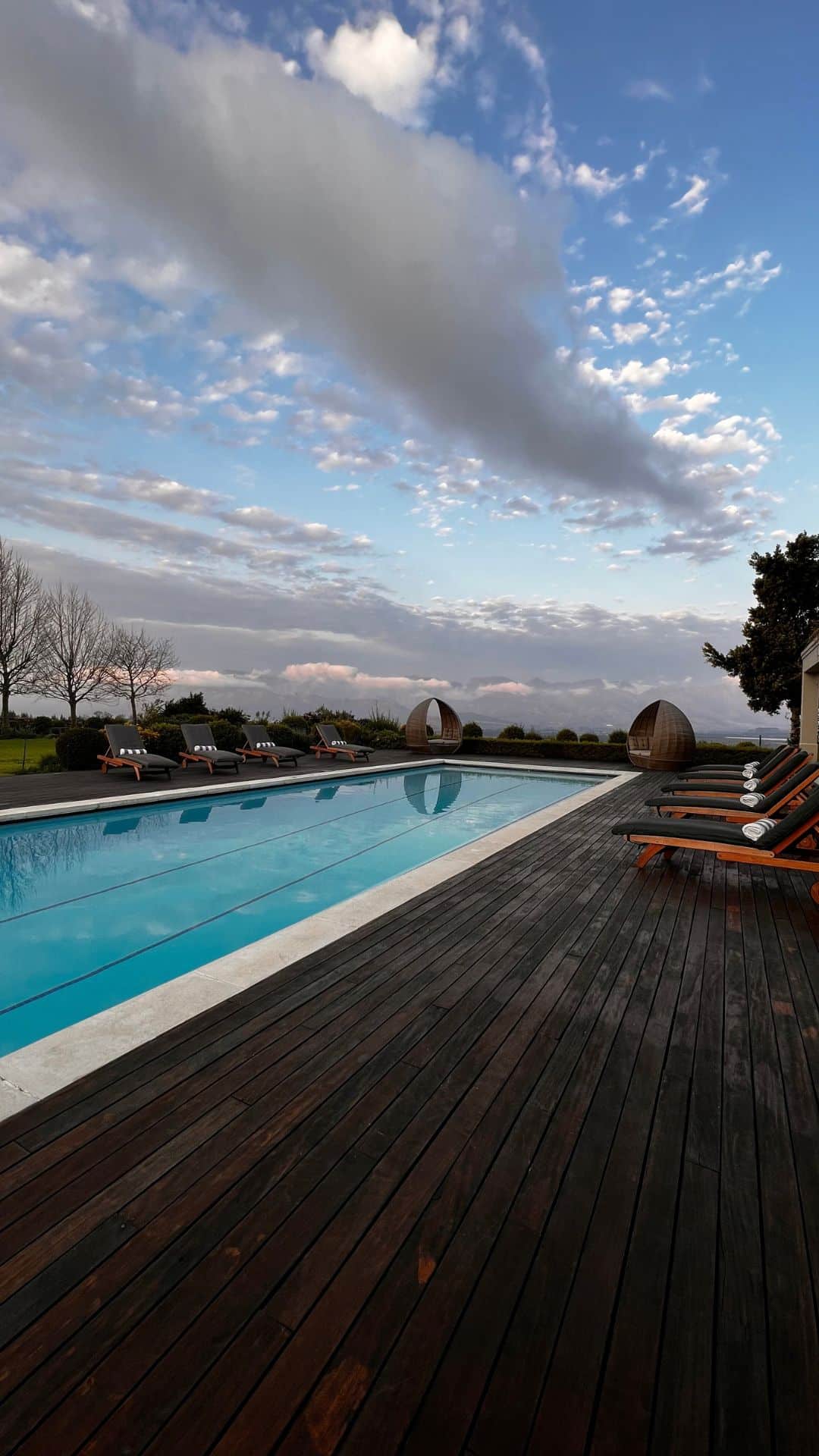 Pool and wooden deck with loungers at the Boschendal Mountain Villa near Stellenbosch