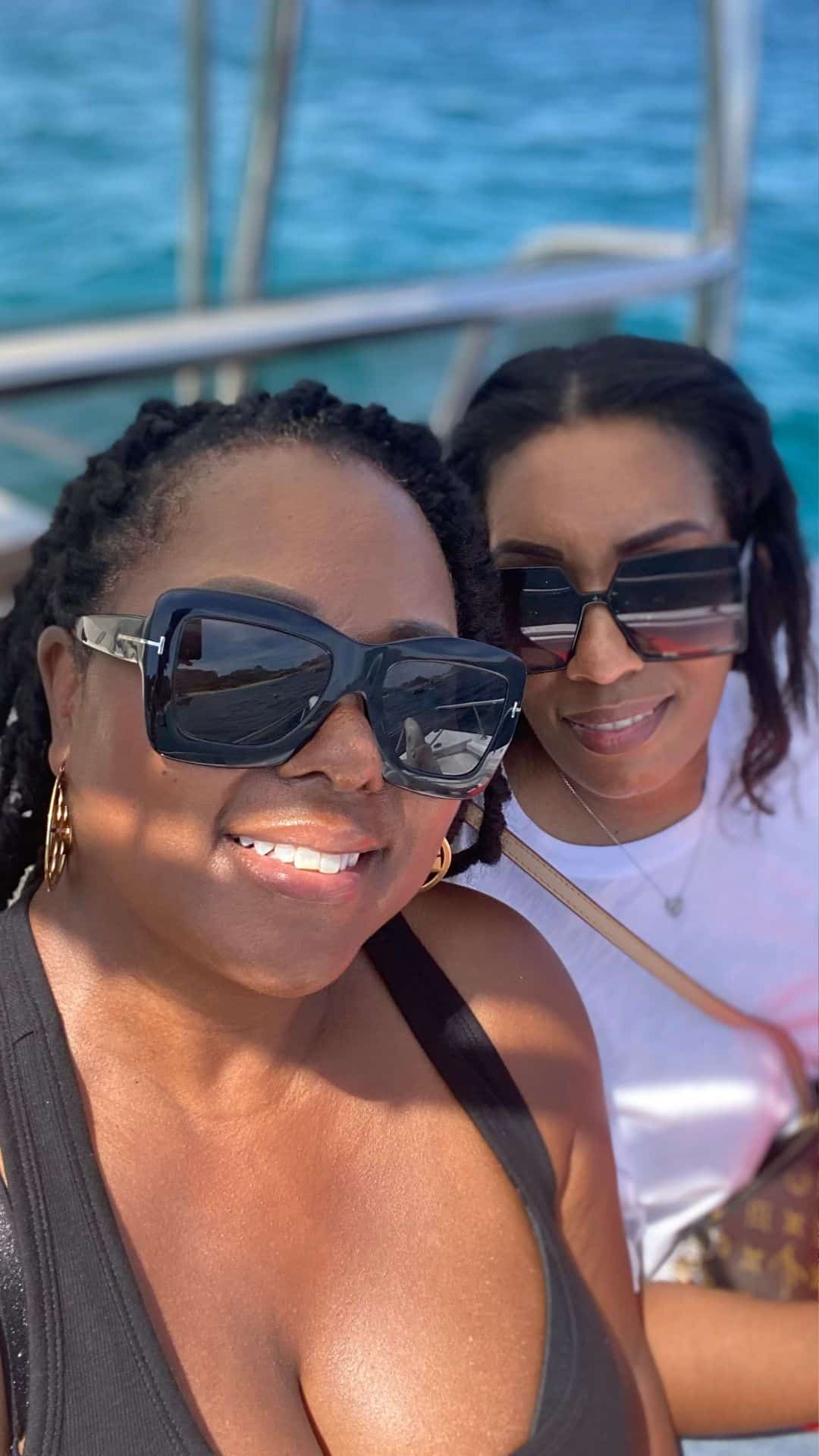Tomiko Harvey and her best friend on a boat during their annual girls' trip to Cancun