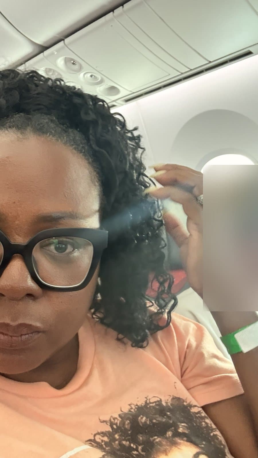 Tomiko Harvey on a long-haul flight beside the passenger who wanted her husband to take Tomiko's aisle seat, face blurred